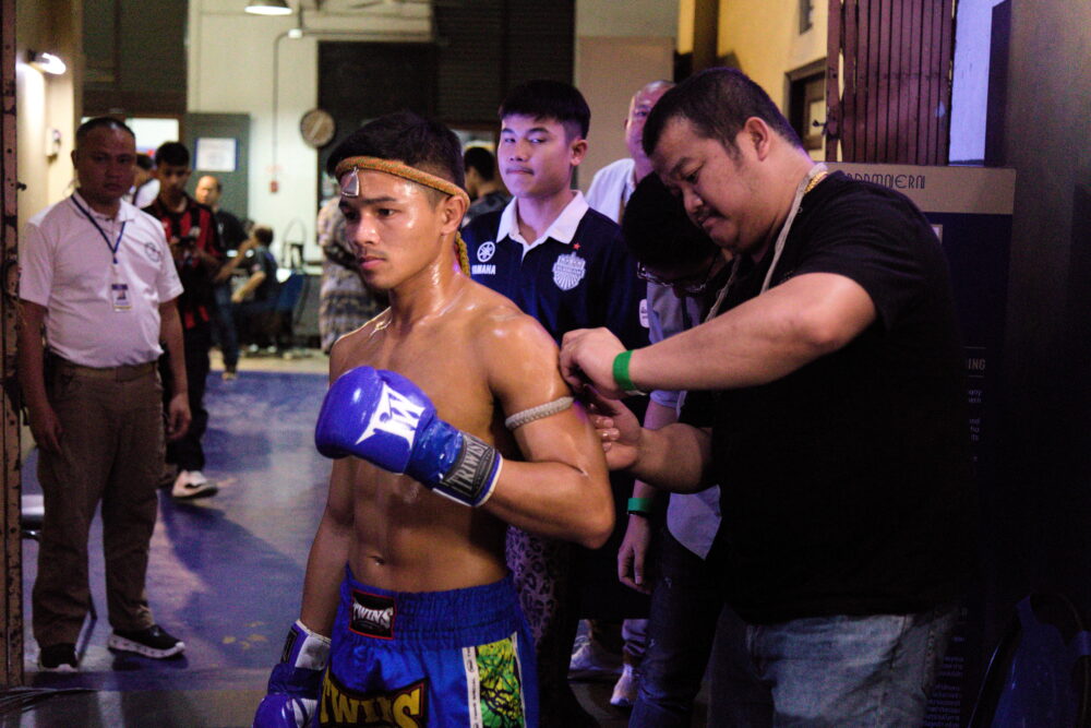 Fighter having his prajiads tied around his arms at Rajadamnern Stadium