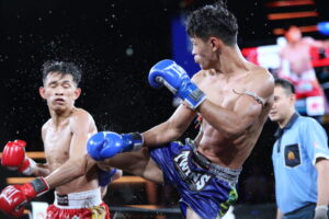 fighter kicks another fighter in the back at rajadamnern stadium